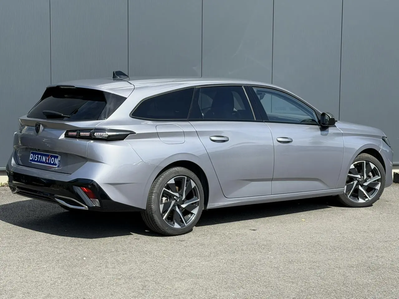 Peugeot 308 SW gris Artense vue 3/4 arrière droit, jantes alliage 17'' et vitres surteintées.