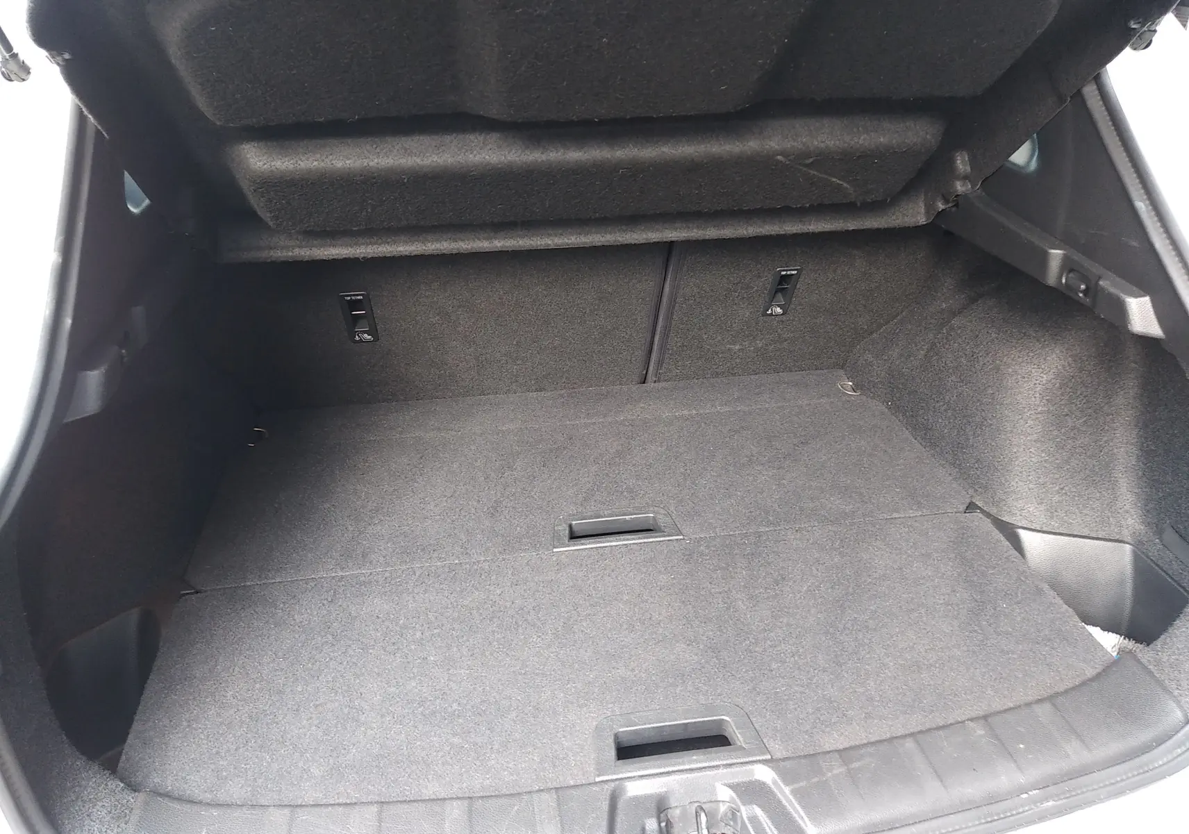 Vue intérieure du coffre spacieux et tapissé de tissu gris du Nissan Qashqai blanc 2018, version Tekna+