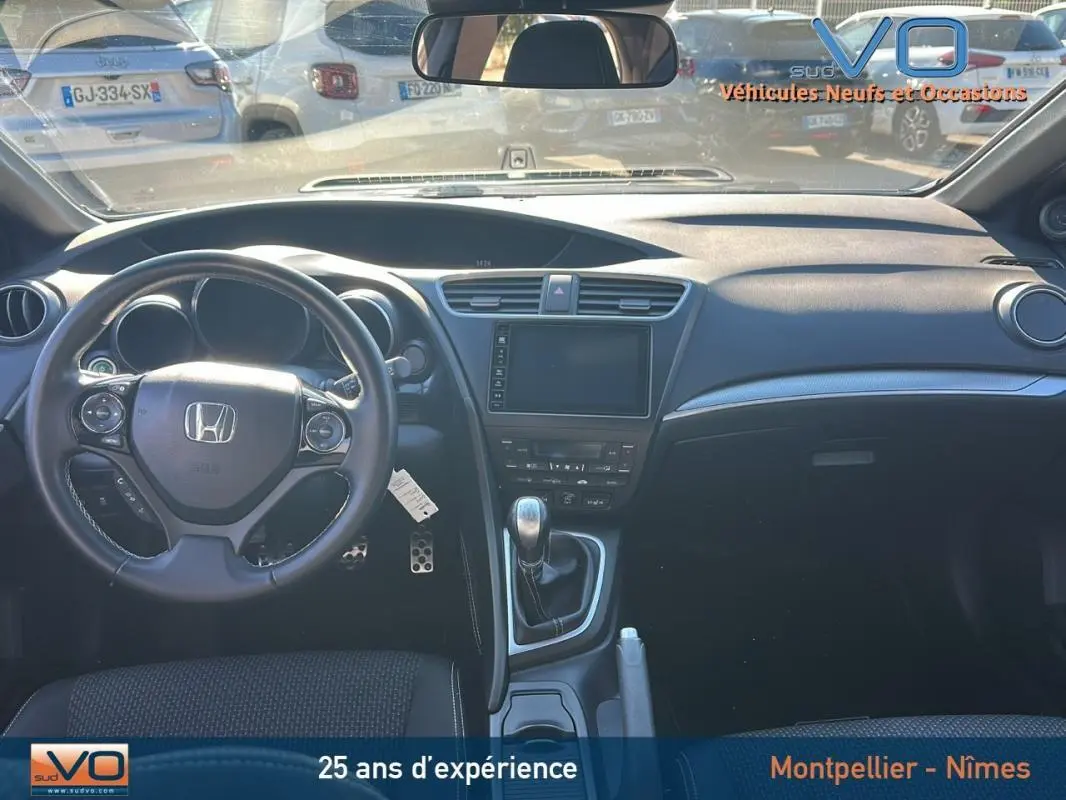 Vue intérieure avant de la Honda Civic 1.6 i-DTEC 120 Elegance 2015 avec volant multifonction et boîte manuelle.