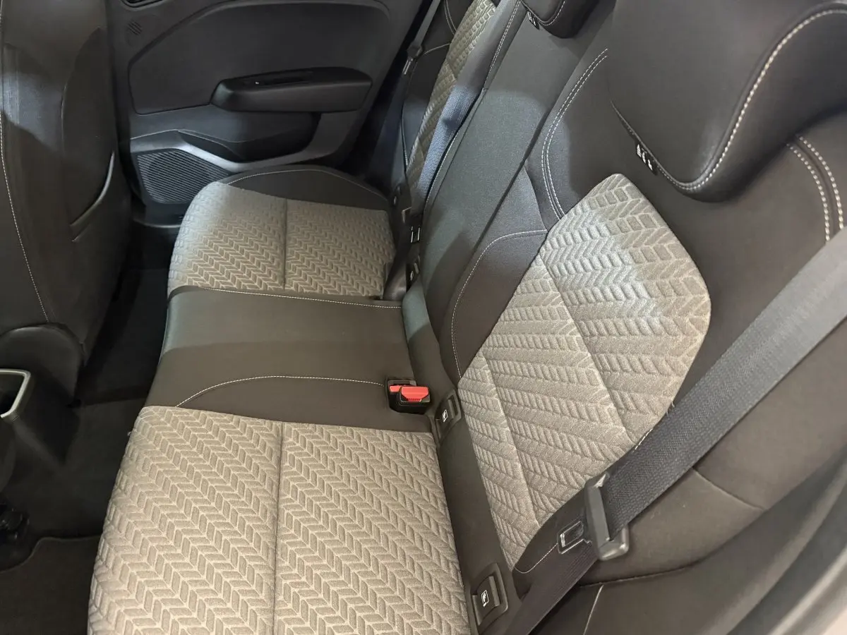 Vue intérieure de la banquette arrière de la Renault Clio Business TCe 100 GPL 2023, tissu gris et noir avec ceinture de sécurité.