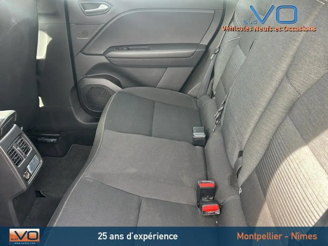 Vue intérieure sur la banquette arrière grise du Renault Captur TCe 100 Business 2020 avec ceintures et portières visibles.