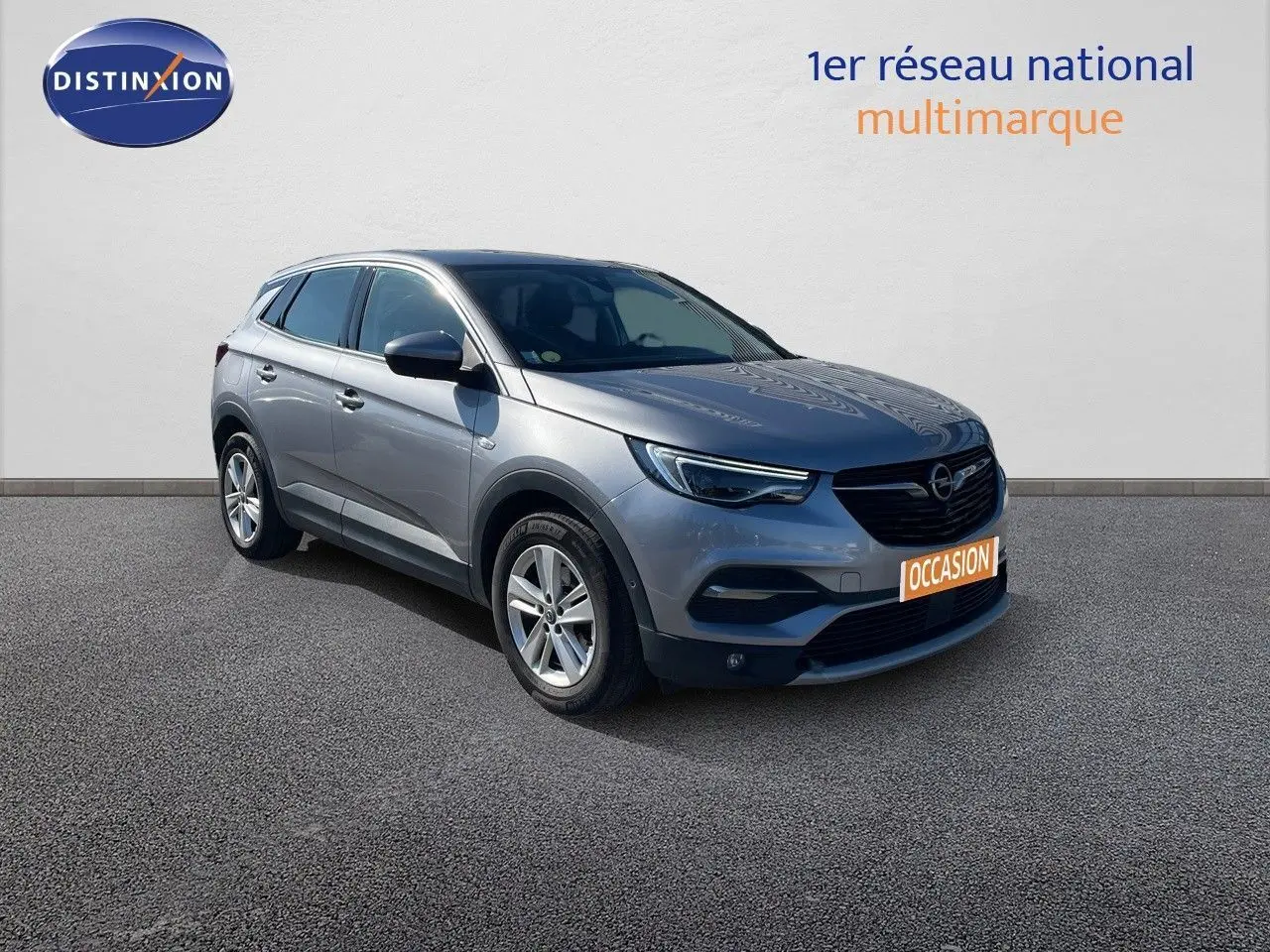 Opel Grandland X gris quartz métal en 3/4 avant droit, avec calandre noire et jantes alliage 17 pouces.