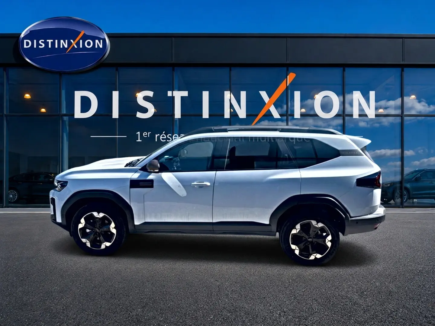 Profil droit du Dacia Bigster blanc 2026, SUV avec jantes alu noires et toit panoramique en verre visible.