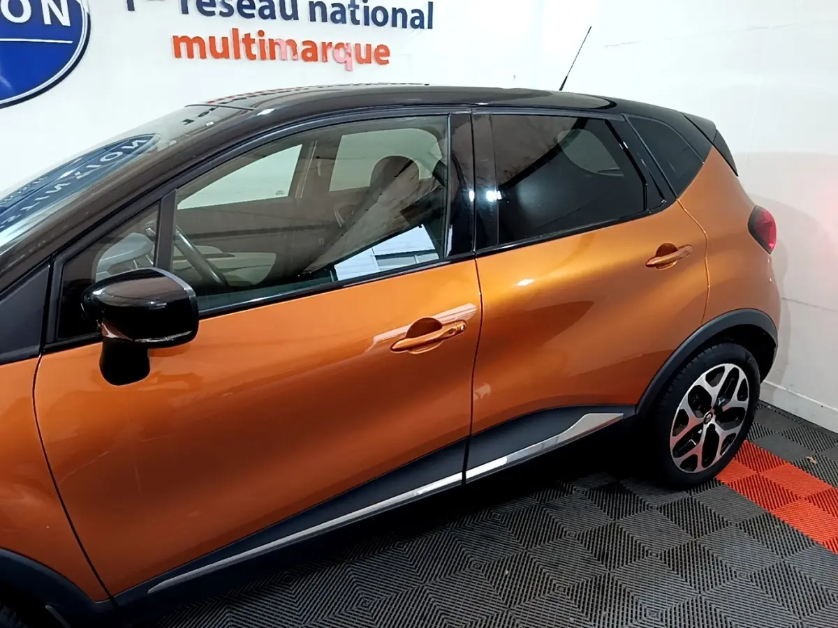 Profil côté gauche du Renault Captur Intens orange 2019 avec toit noir et jantes alliage distinctives.