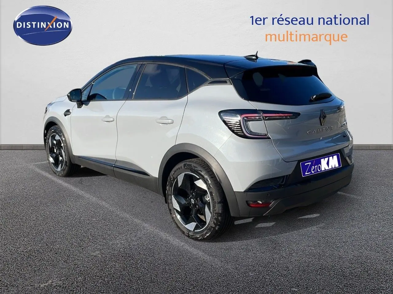 Renault Captur E-Tech hybride gris Rafale avec toit noir, vu en 3/4 arrière côté gauche sur parking.