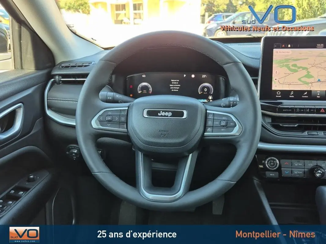 Vue centrée sur le volant et le tableau de bord du Jeep Compass 2023 avec écran tactile et commandes au volant.