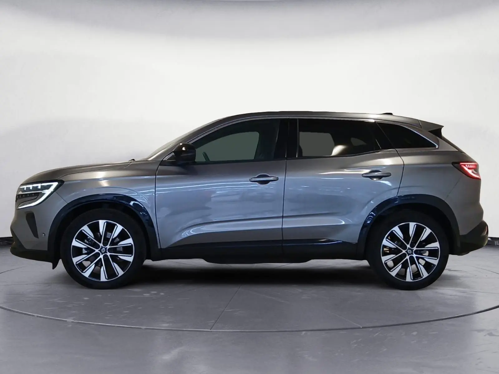Renault Austral E-Tech hybride 2024 gris métallisé, vue profil côté gauche avec jantes alliage 19 pouces.