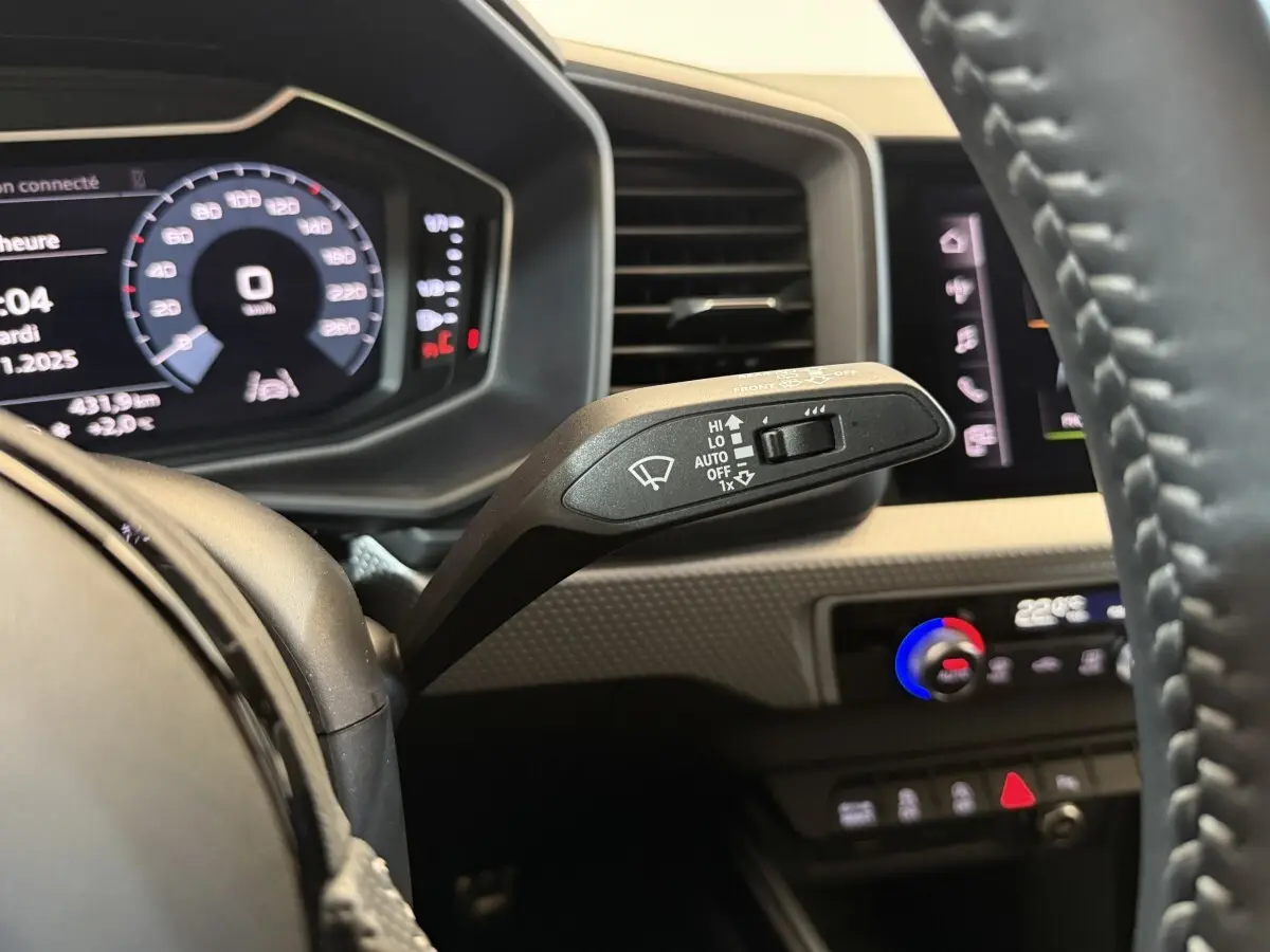 Gros plan sur la commande d’essuie-glace côté droit du tableau de bord de l’Audi A1 gris foncé, intérieur moderne.