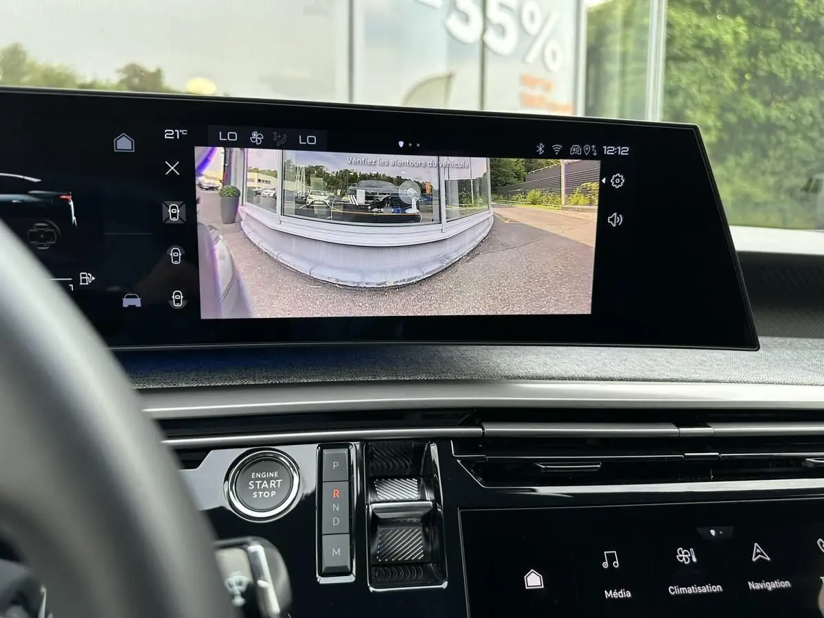 Vue intérieure du tableau de bord du Peugeot 3008 gris Artense 2024, écran central affichant la caméra de recul.