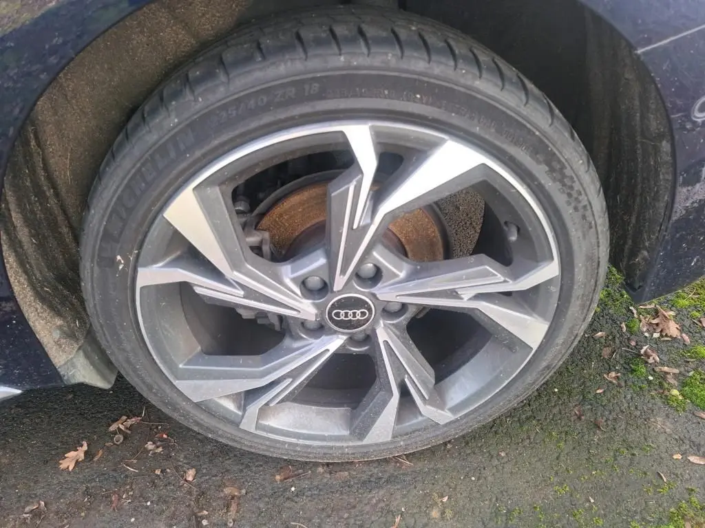 Audi A3 2.0 TDI bleu vue 3/4 arrière droit, avec jantes alliage et feux arrière LED distinctifs.