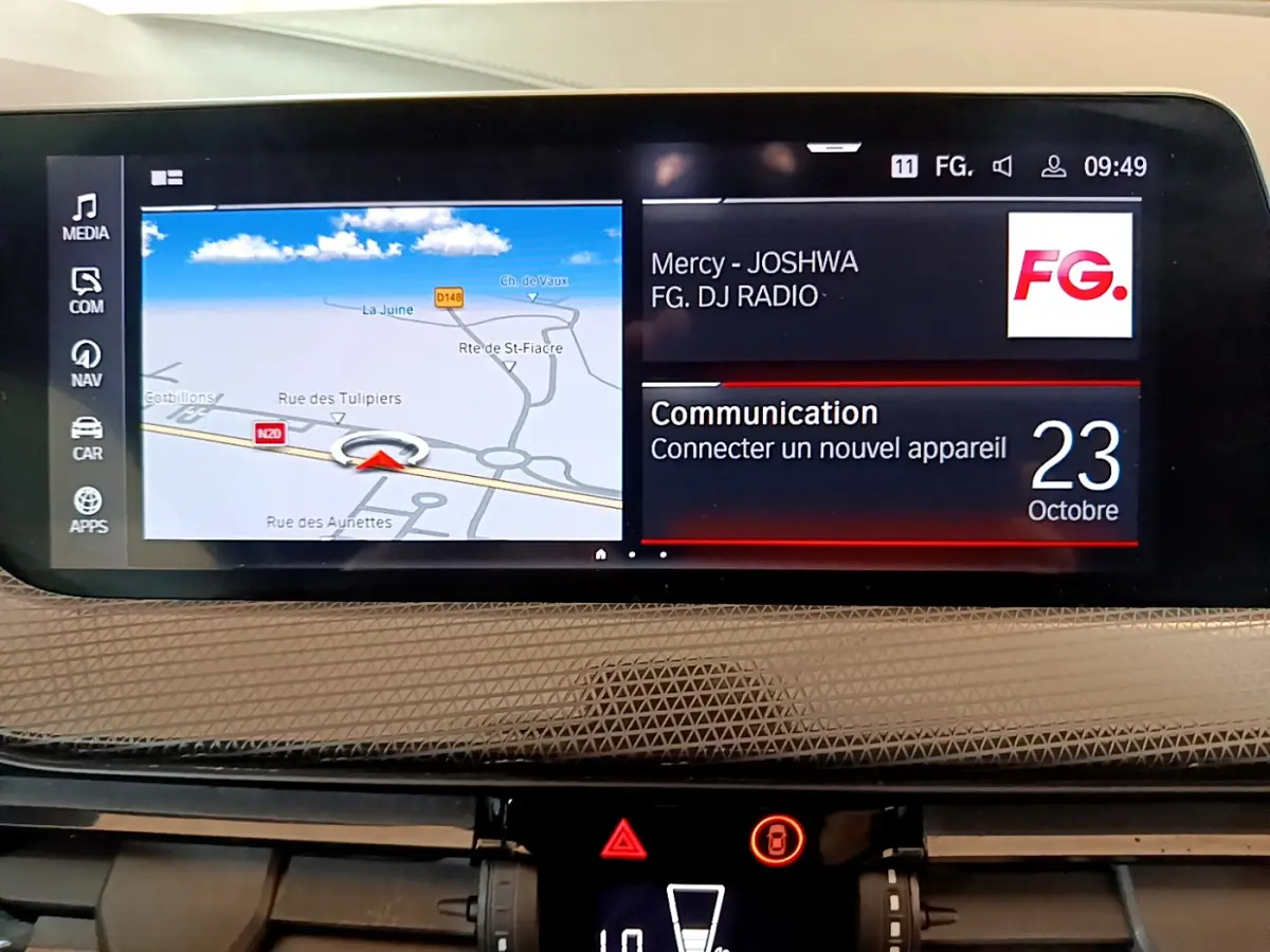 Écran central du tableau de bord de la BMW Série 1 gris clair, affichant navigation et radio FG à 09h49