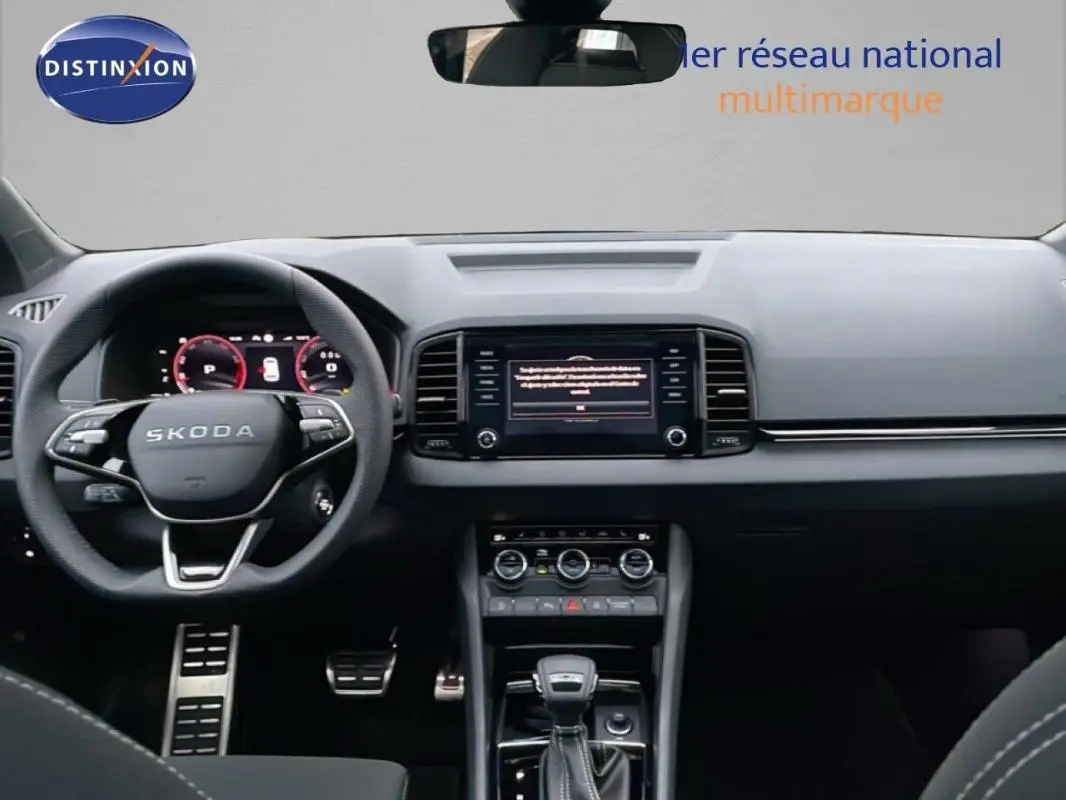 Vue intérieure du tableau de bord et volant cuir noir du Skoda Karoq 1.5 TSI 2025 avec écran tactile central.