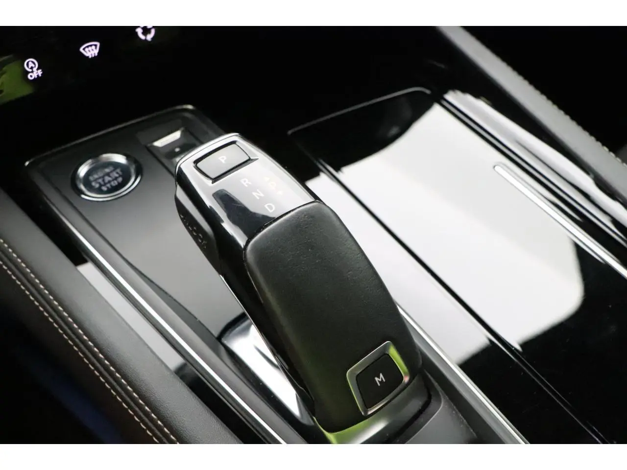 Le levier de boîte automatique noir et brillant de la Peugeot 508 SW GT Line vu en gros plan sur la console centrale.