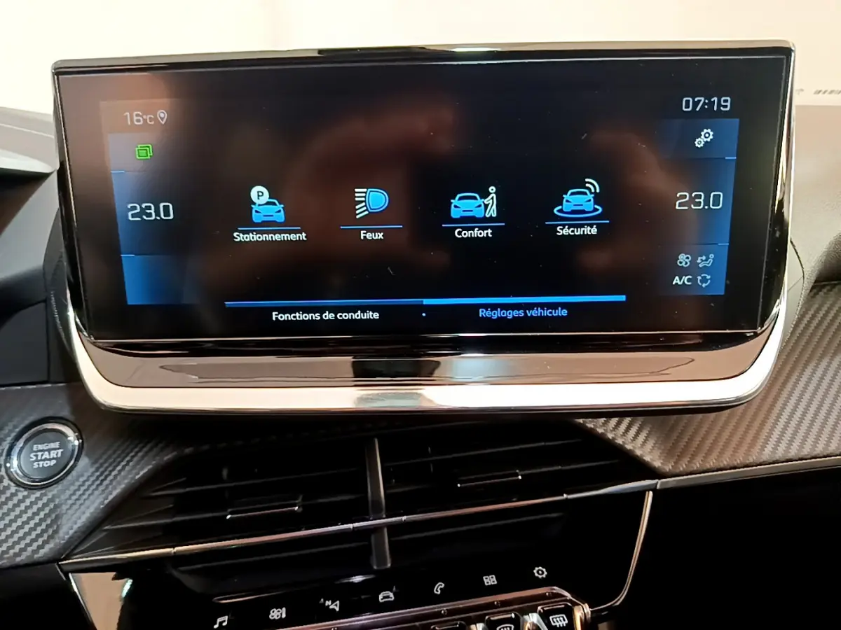 Écran tactile central affichant les réglages de conduite et climatisation dans le tableau de bord du Peugeot 2008 gris clair.