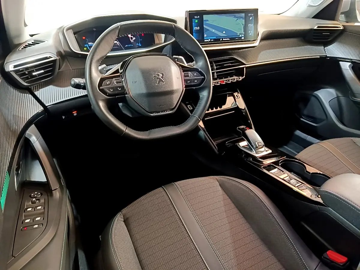 Intérieur du Peugeot 2008 2021 vu côté conducteur, volant cuir, écran tactile 10 pouces et console centrale noire.
