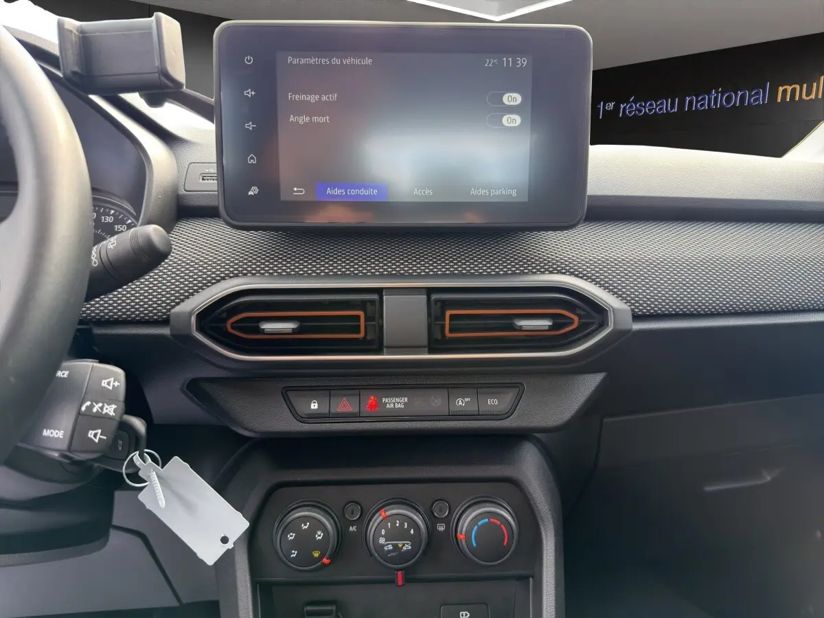 Vue intérieure centrée sur le tableau de bord de la Dacia Sandero Stepway 2022 avec écran tactile et commandes climatisation.