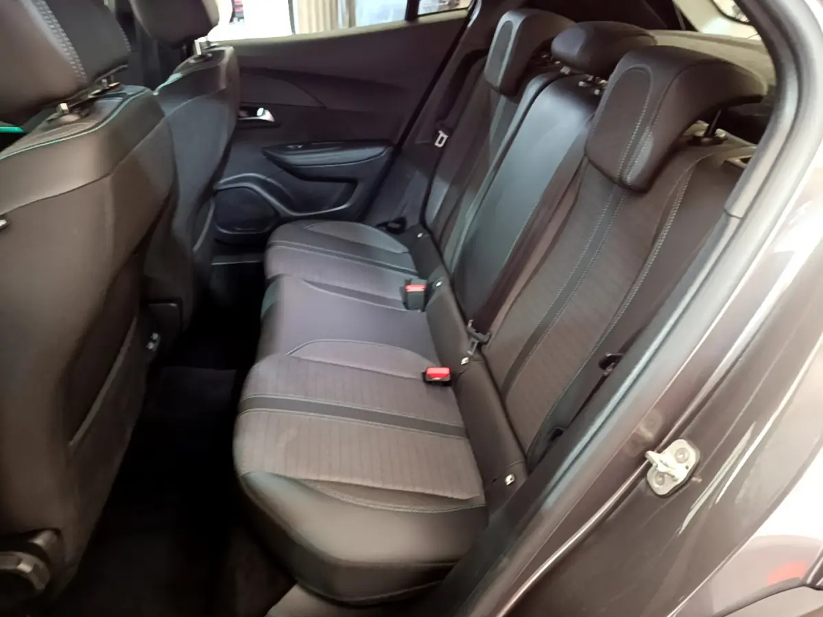 Vue intérieure côté droit sur la banquette arrière noire du Peugeot 2008 gris foncé avec ceintures et appuie-têtes visibles.