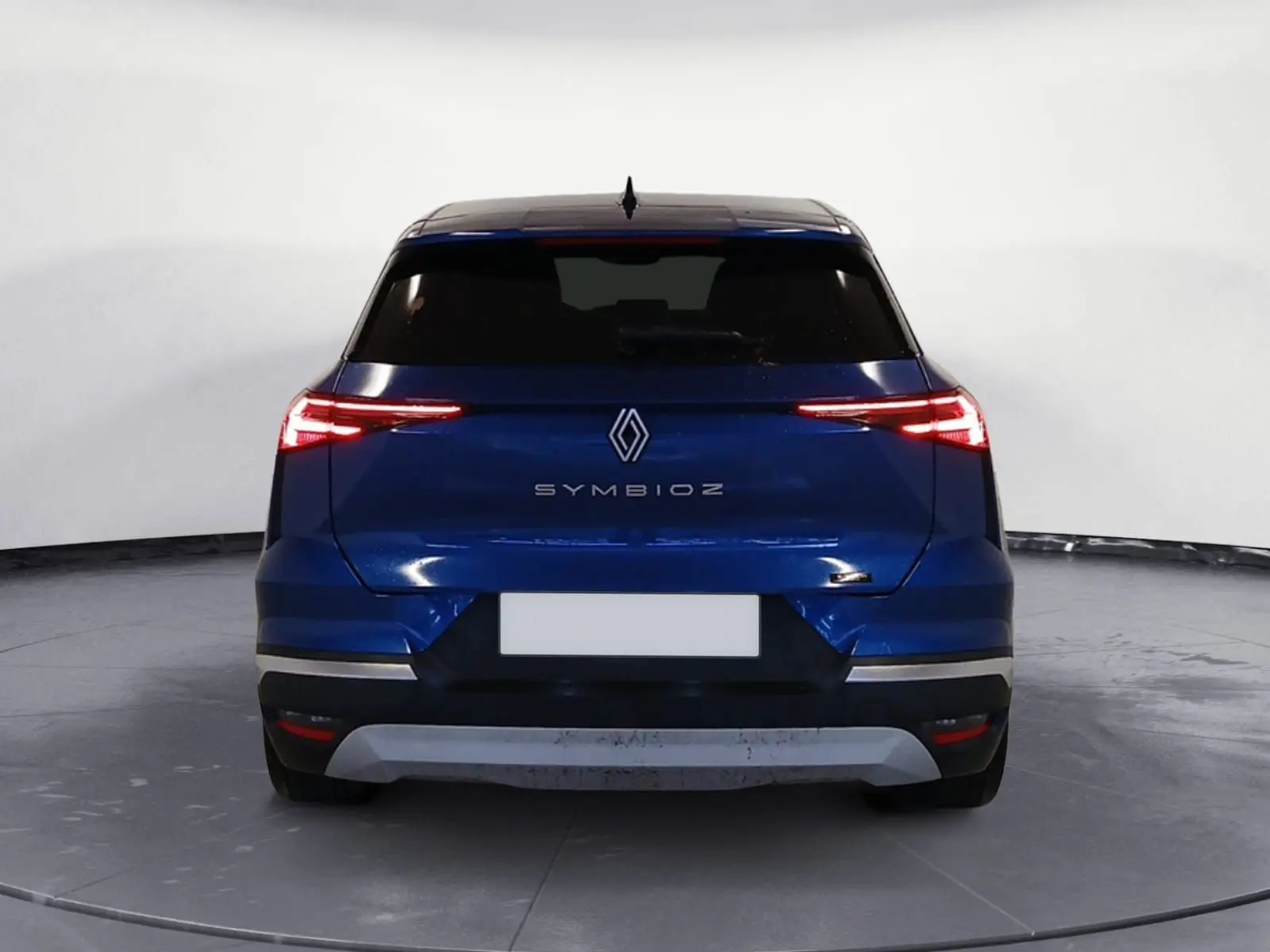 Vue arrière du Renault SYMBIOZ E-TECH Full Hybrid 145 Iconic 2025 en bleu iron avec feux LED fins allumés.