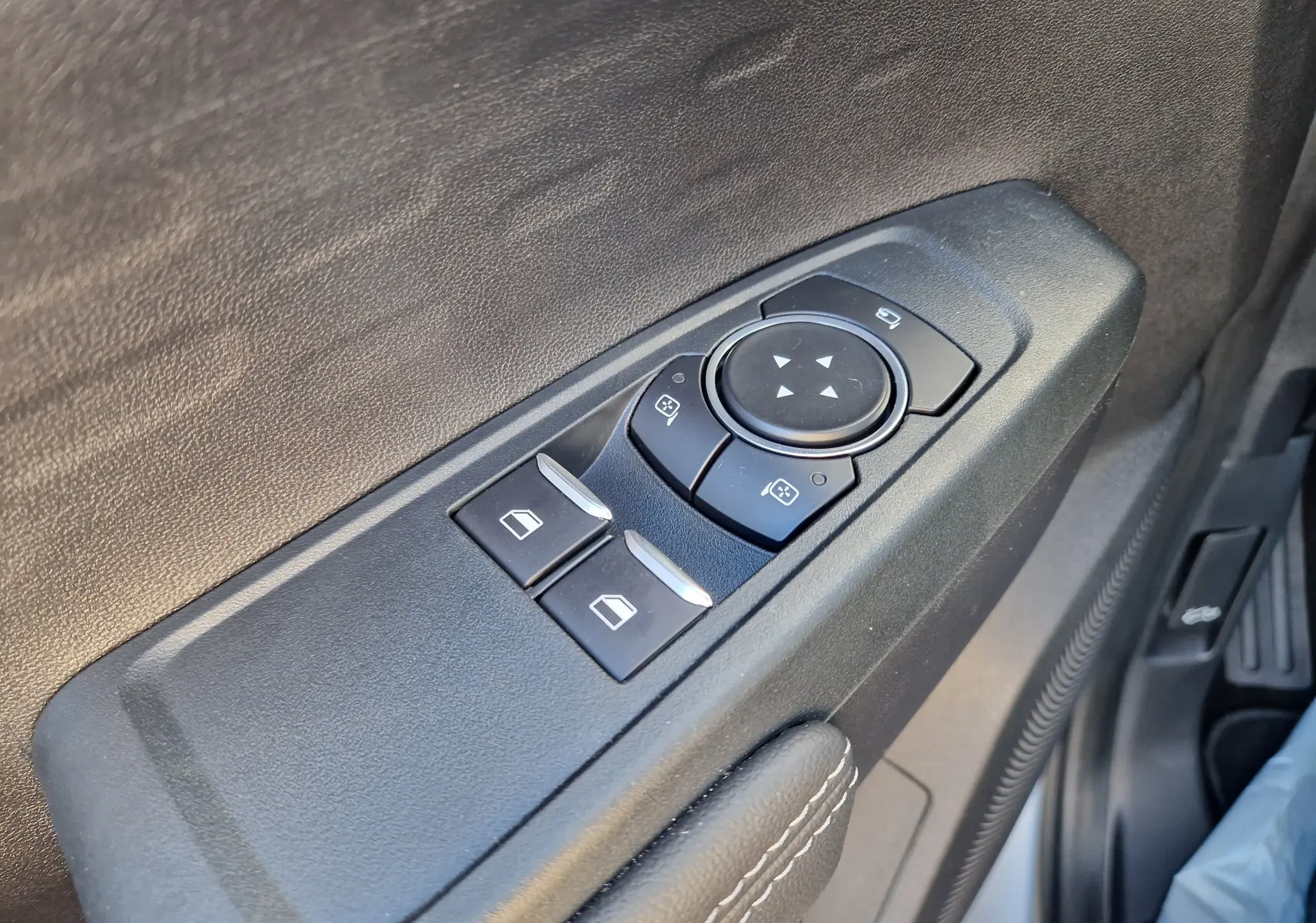 Gros plan sur les commandes des vitres et rétroviseurs côté conducteur du Ford Ranger Super Cabine gris Iconic 2026.