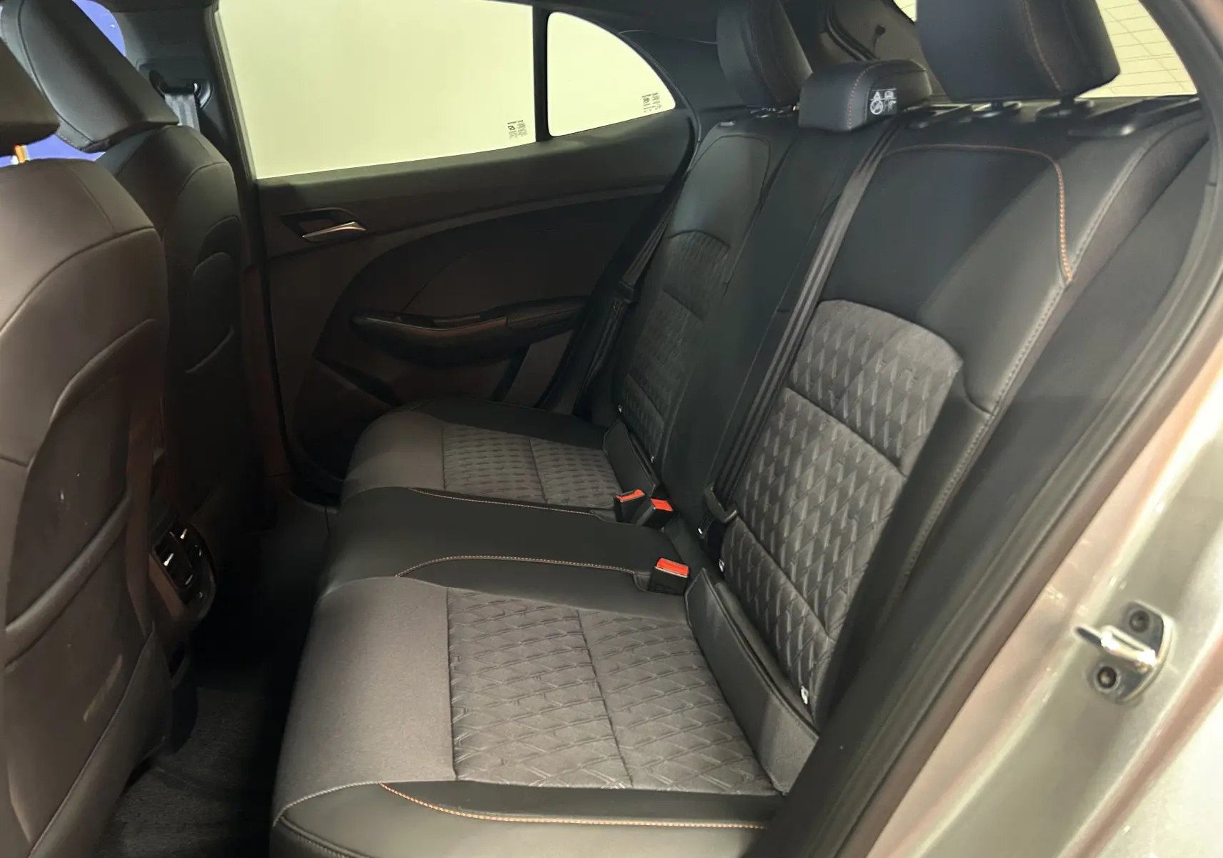 Vue côté droit de la banquette arrière en cuir noir et tissu gris du MG3 Cosmic Silver 2026, avec surpiqûres orange visibles.