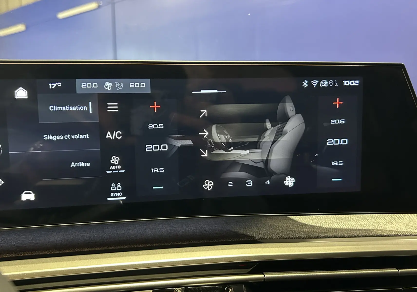 Écran tactile intérieur du Peugeot 5008 Hybrid gris titane, affichant les réglages de climatisation et sièges.