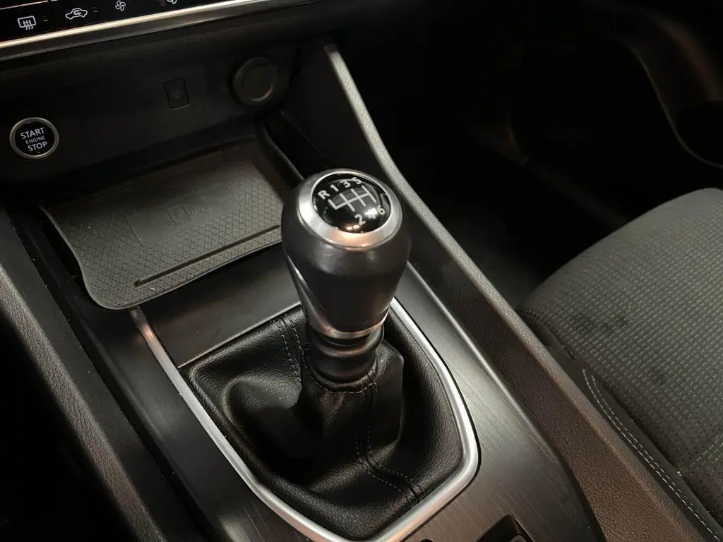 Gros plan sur le levier de vitesses manuel noir et argenté du Nissan Qashqai 1.3 Mild Hybrid 140 Business Edition 2023.