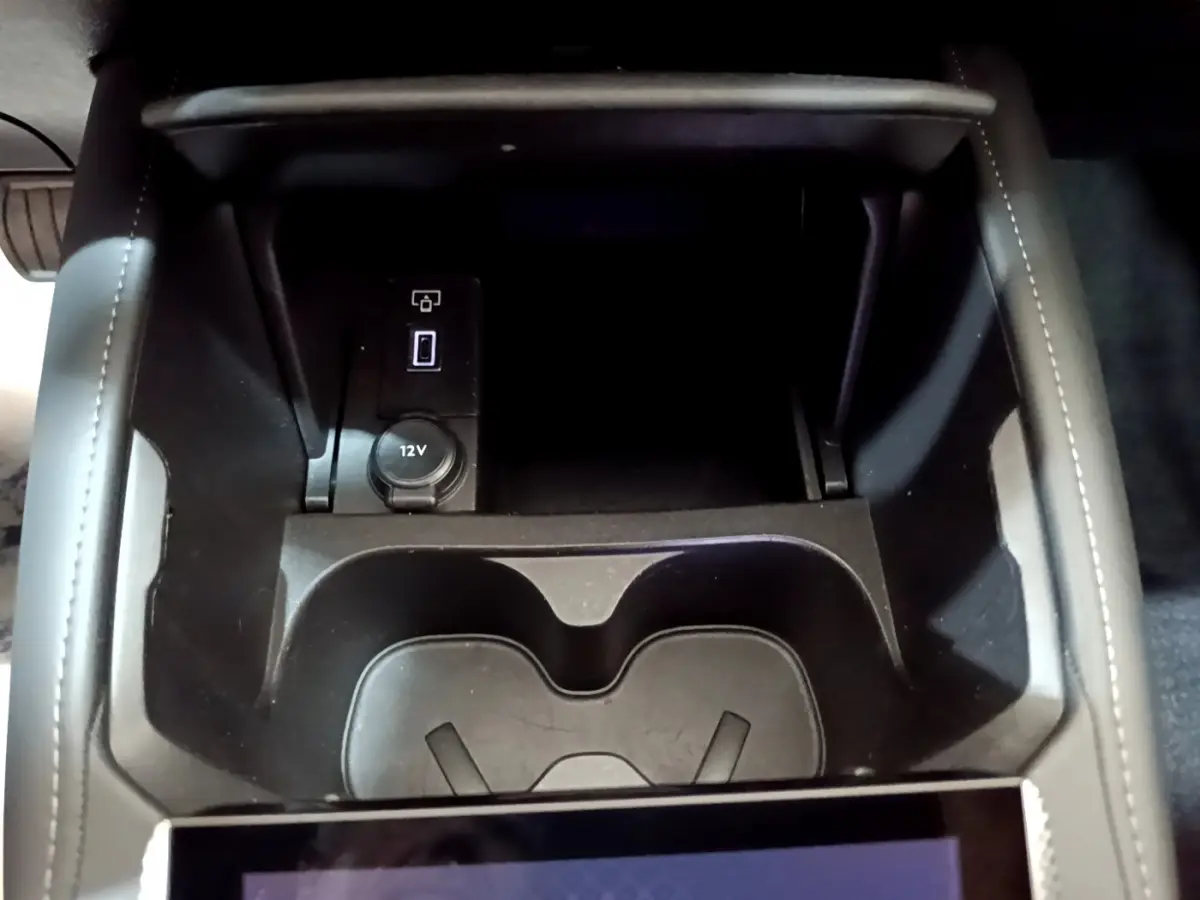 Gros plan sur la console centrale noire du DS4 E-TENSE 225 TROCADERO 2023 avec prise 12V et port USB visible.