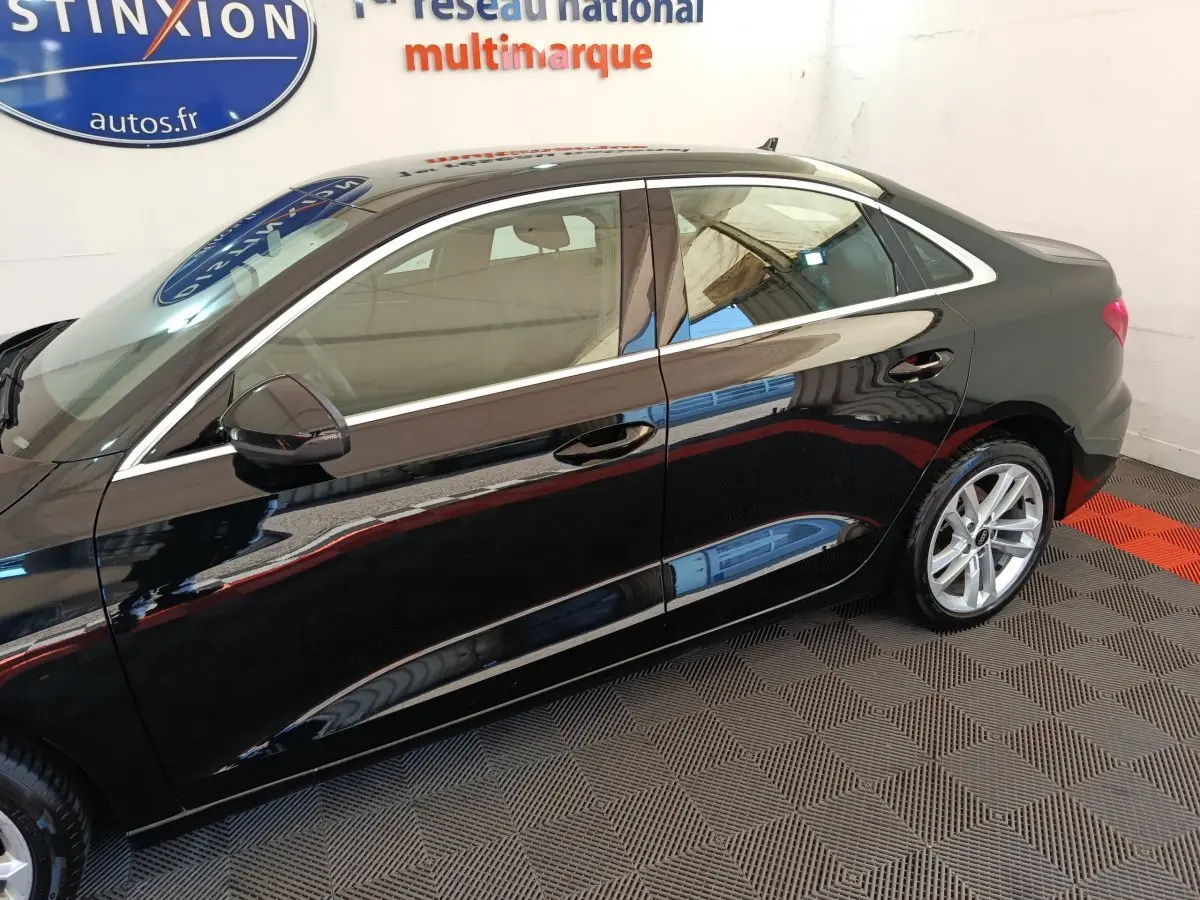 Profil côté gauche d'une Audi A3 Business Line noire 2022, avec jantes alliage et rétroviseurs noirs brillants.