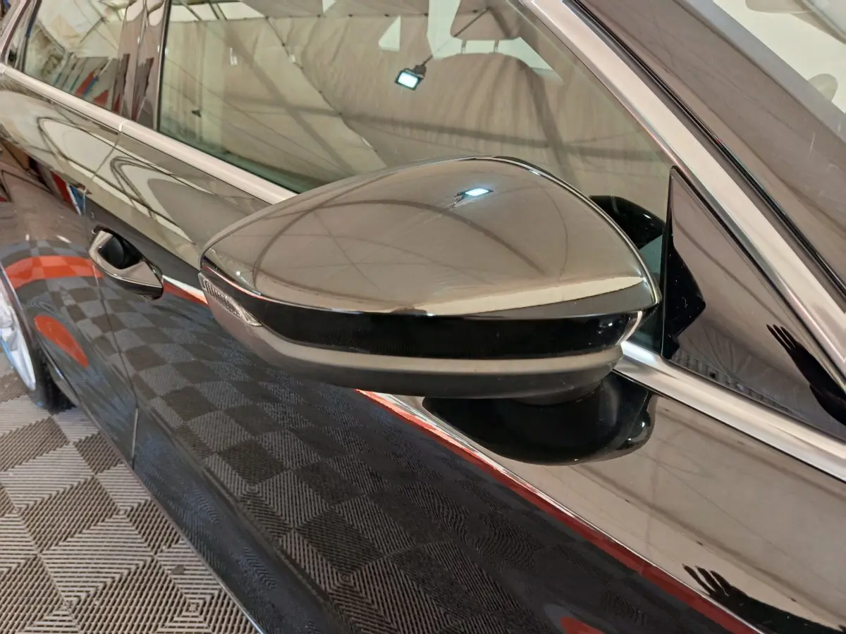 Rétroviseur côté gauche noir brillant de l'Audi A3 30 TFSI MHEV S Tronic 2022 avec carrosserie noire reflet intérieur.