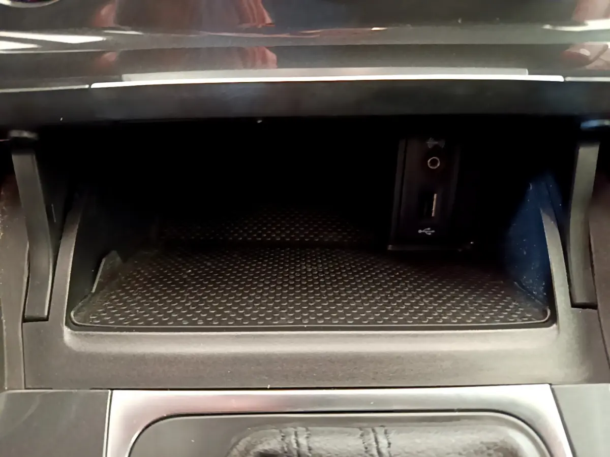 Rangement intérieur noir avec prise USB et entrée audio dans une Volkswagen Golf 2019, vue frontale rapprochée.
