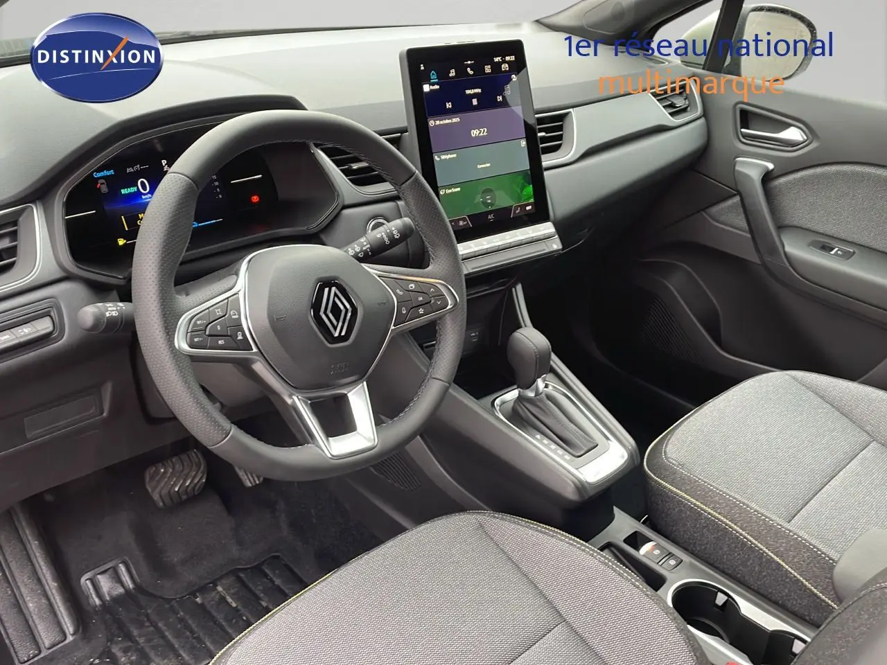 Vue intérieure côté conducteur du Renault Captur E-Tech hybride 2025, avec volant multifonction et écran tactile central.