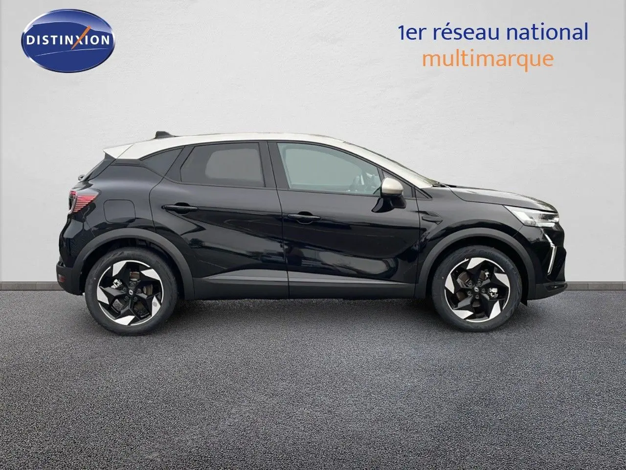 Renault Captur E-Tech hybride 2025 en profil côté gauche, noir étoile avec toit beige et jantes bicolores.
