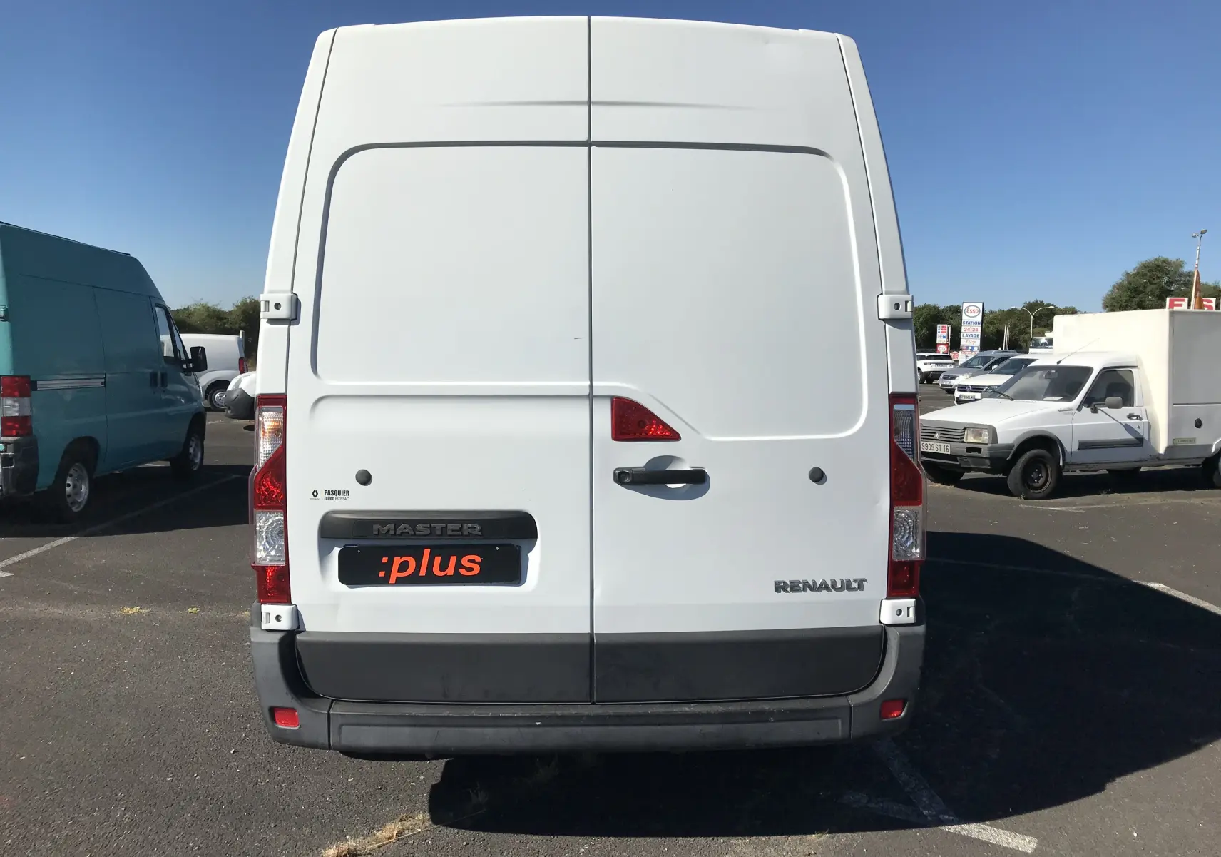 Vue arrière d’un utilitaire Renault Master blanc, portes battantes fermées, avec logo et plaque :plus visible.