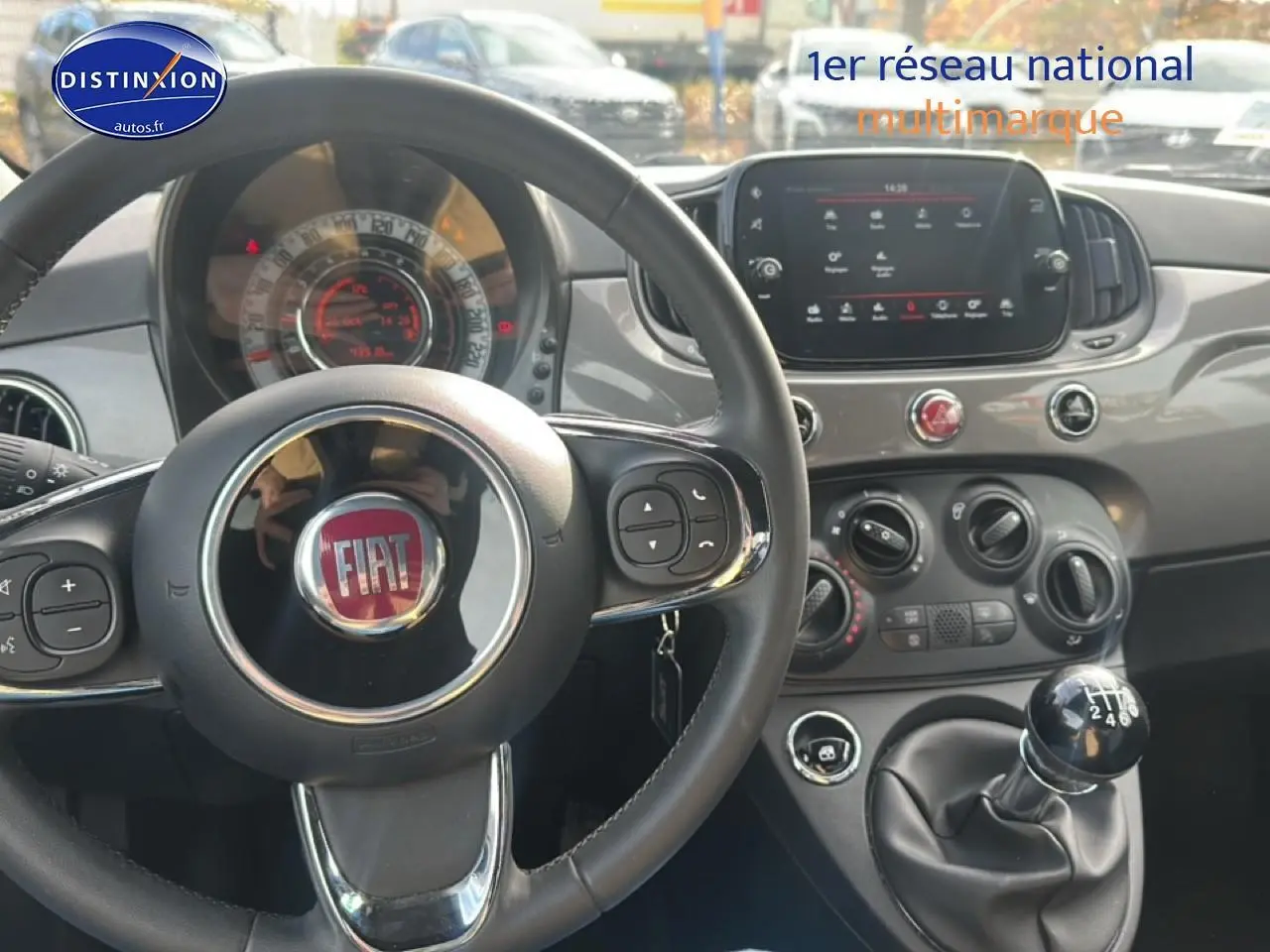 Intérieur de la Fiat 500 1.0 70 bsg cult 2022, vue centrée sur le volant cuir et la console avec boîte manuelle.