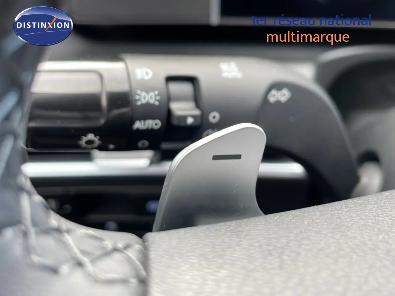 Gros plan sur la palette de changement de vitesse côté droit du volant du Hyundai Tucson blanc Atlas, intérieur noir.