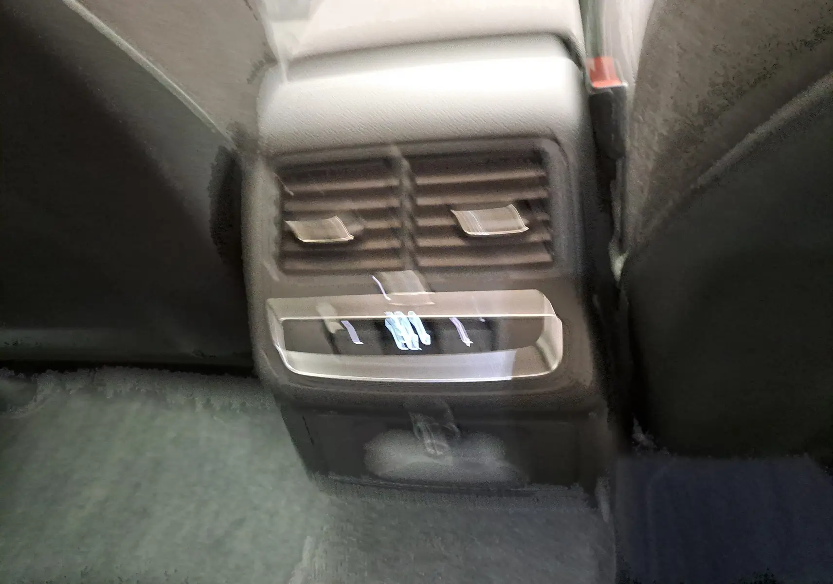 Vue rapprochée des commandes de ventilation arrière et chargeur USB dans l’Audi A4 Avant 40 TDI gris Daytona 2024.