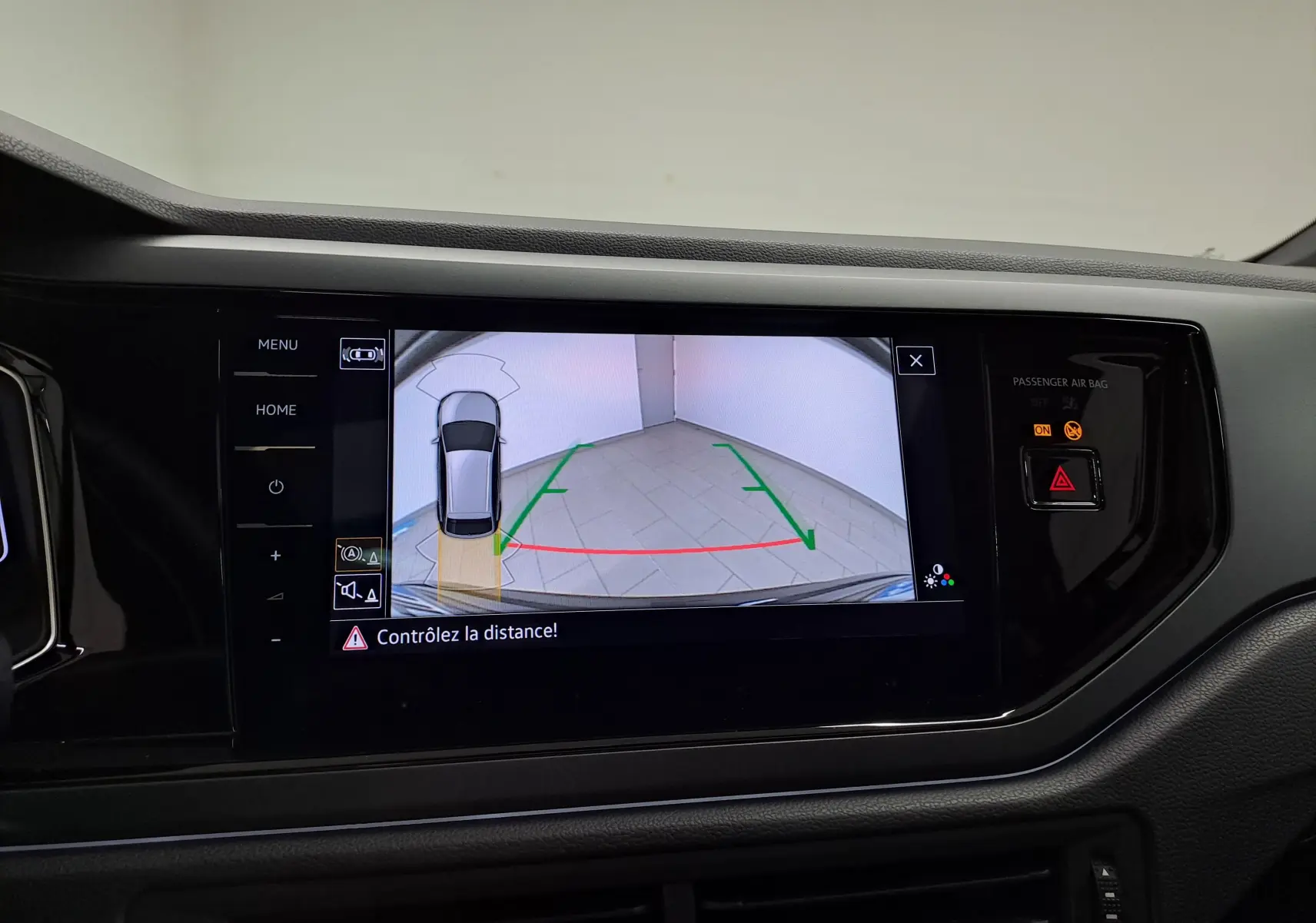 Vue intérieure sur l'écran tactile affichant la caméra de recul et l'aide au stationnement du Volkswagen Taigo noir intense nacré.