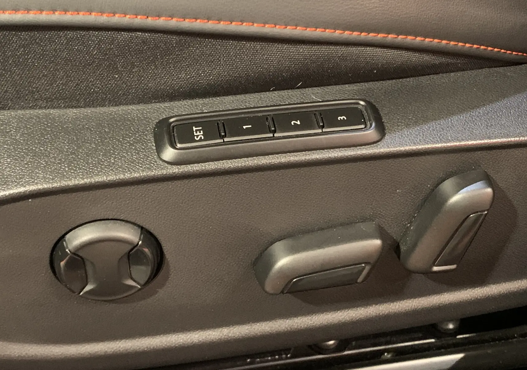 Boutons de réglage électrique des sièges avec mémoire sur la porte intérieure d'une SEAT Leon gris 2020 E-HYBRID.