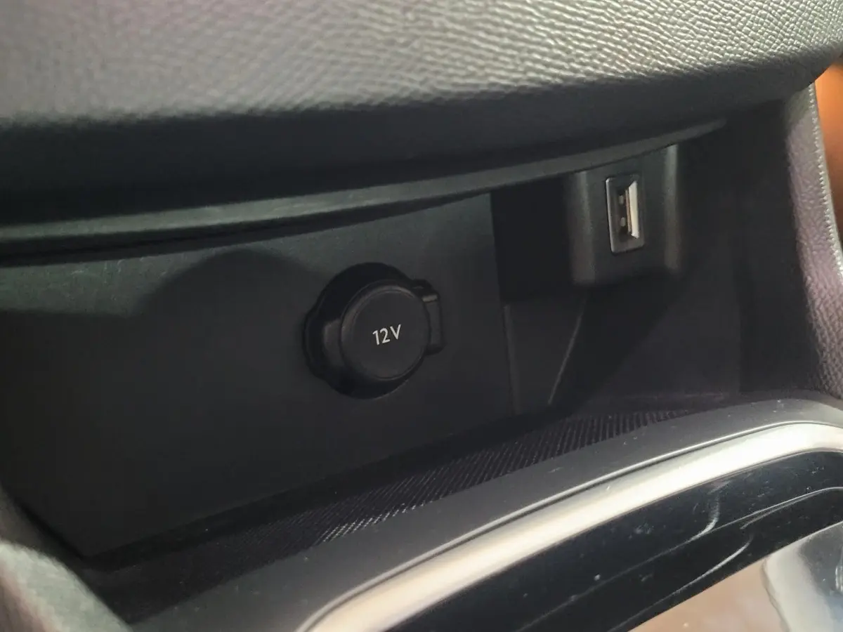 Prise 12V et port USB en gros plan dans l'habitacle noir de la Peugeot 308 BlueHDi 130 EAT8 Allure Business 2020