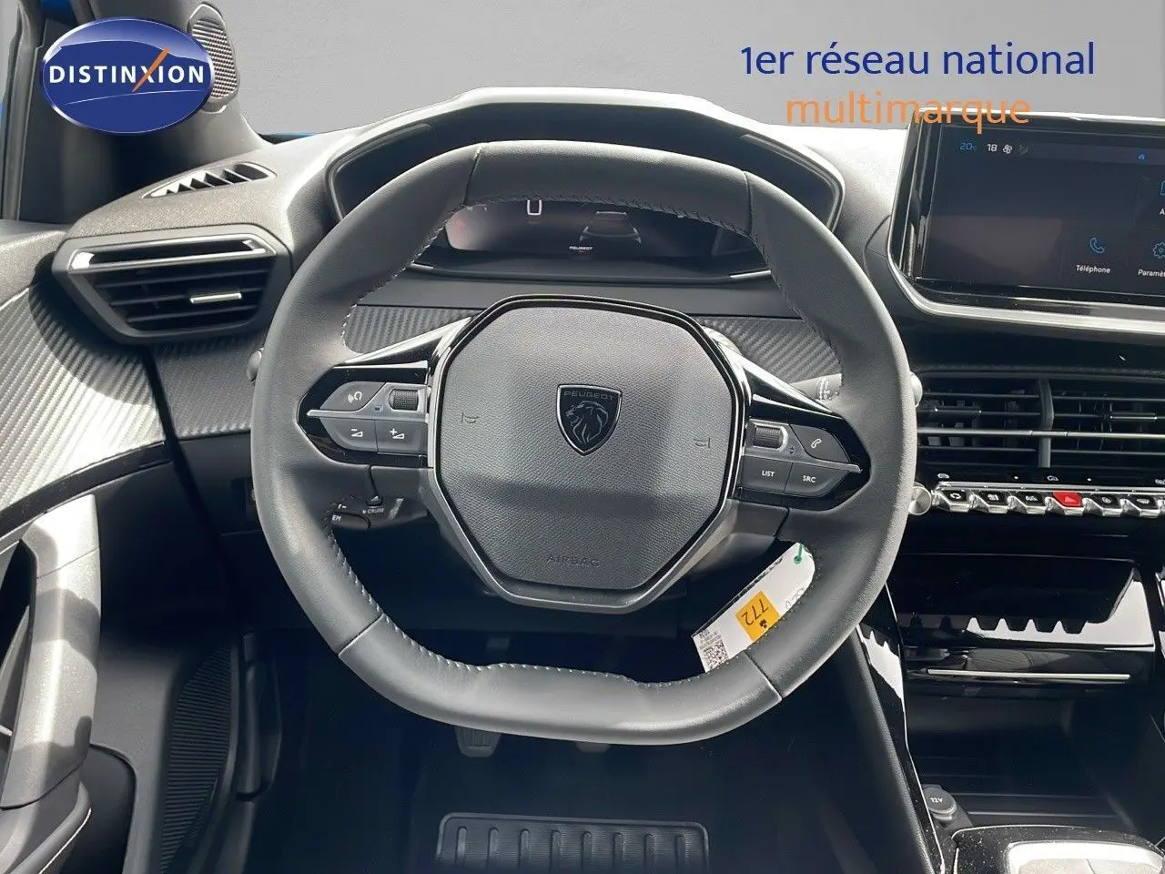 Vue rapprochée du volant cuir noir du Peugeot 2008 2024, avec tableau de bord numérique et écran tactile central.