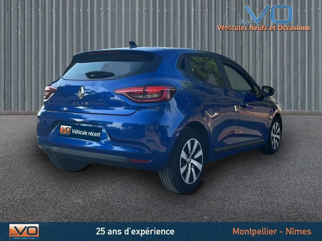 Vue 3/4 arrière droite d'une Renault Clio bleu foncé 2023 avec feux arrière LED et jantes alliage.