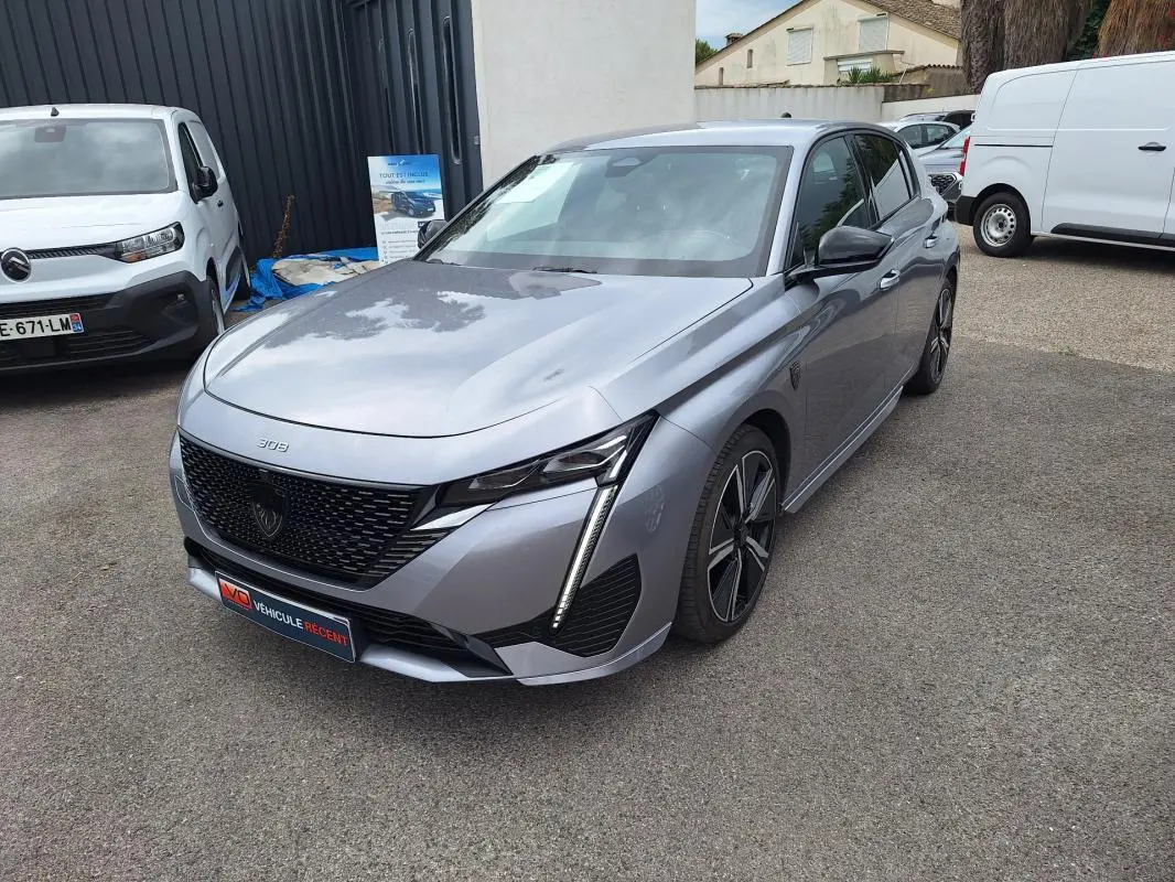 Peugeot 308 Hybrid gris vue 3/4 avant droit, avec calandre noire et jantes alliage 18 pouces.