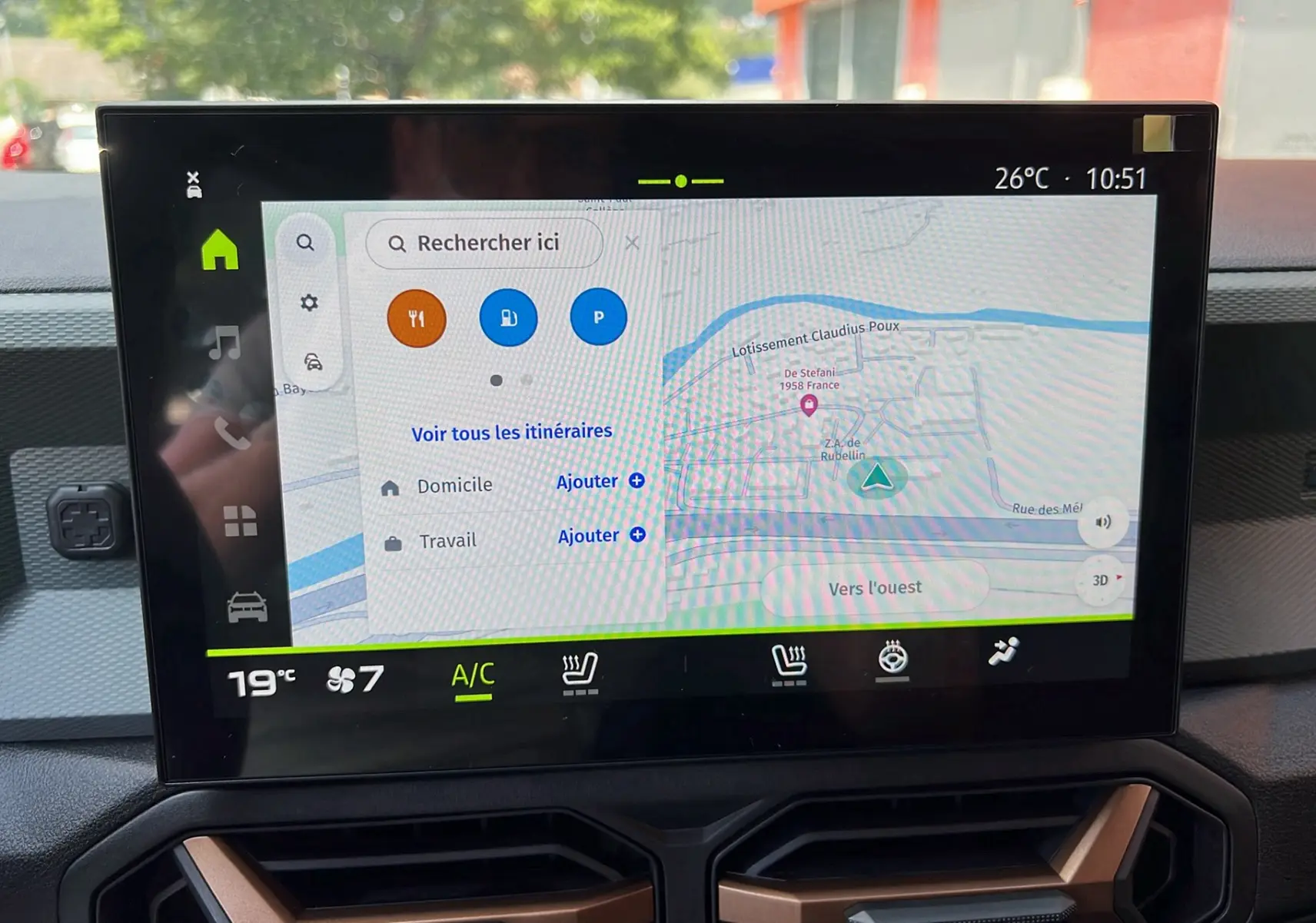Écran tactile central du Dacia Duster 2025 affichant la navigation et les commandes climatisation en intérieur.