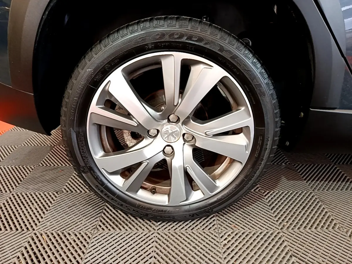 Gros plan sur la roue avant droite gris foncé d'un Peugeot 2008 2019 avec jante alliage et pneu Goodyear.