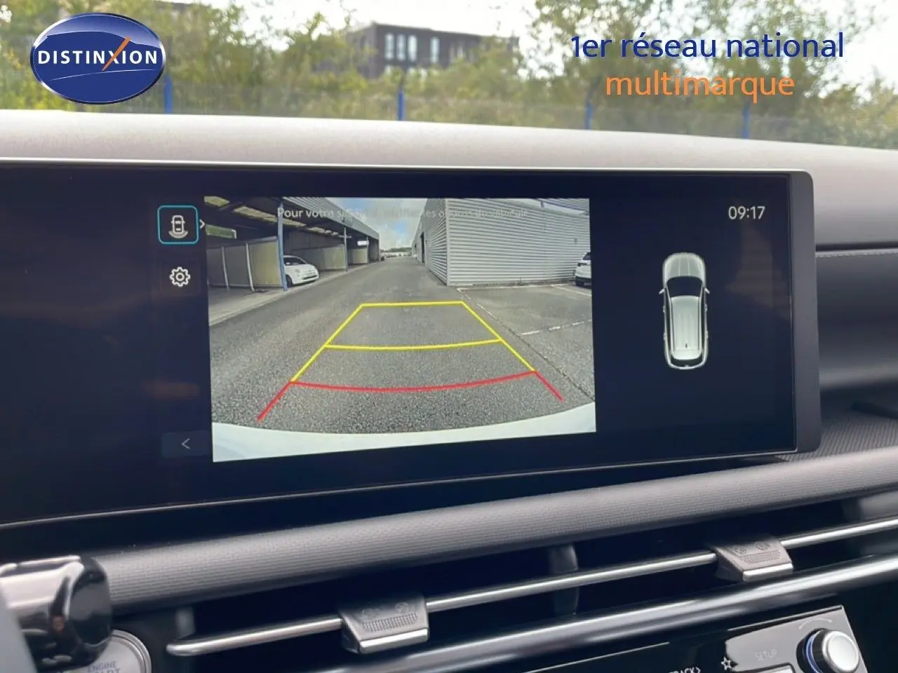 Écran intérieur affichant la caméra de recul du Hyundai Tucson blanc Atlas, vue arrière avec lignes de guidage colorées.