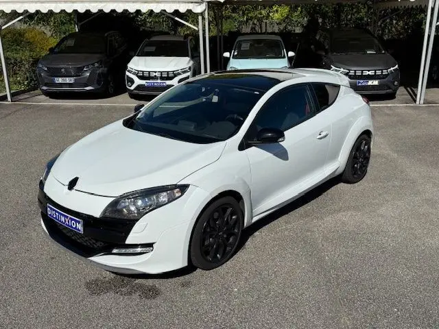 Renault Mégane III Coupé 2.0T 265cv RS blanc nacré vue 3/4 avant droit avec jantes noires et toit noir.