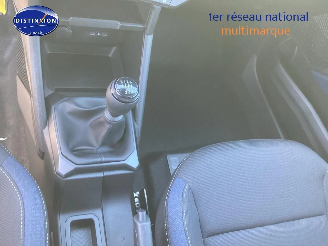 Gros plan sur la boîte manuelle et siège avant droit tissu gris du Dacia Duster noir 2025, intérieur fonctionnel.