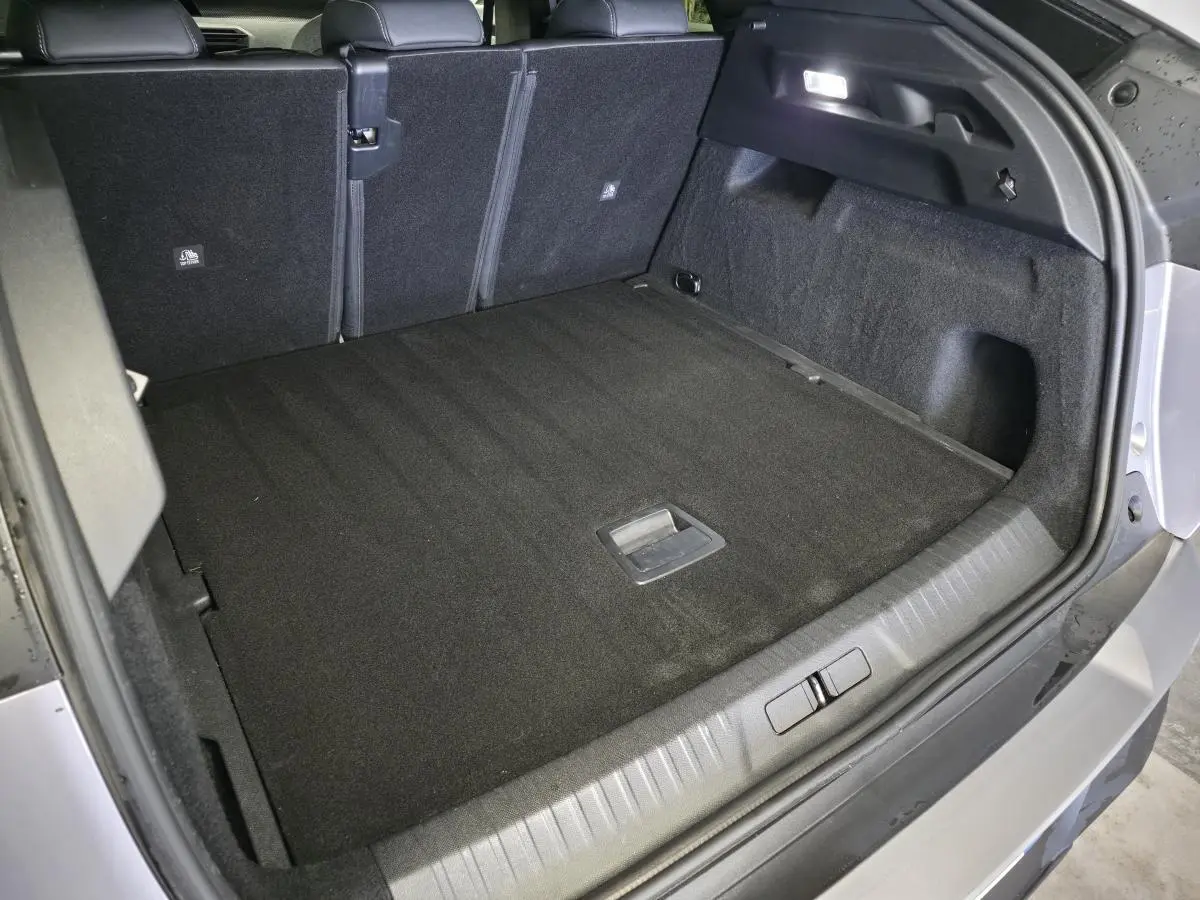 Coffre ouvert vu de l'arrière droit du Peugeot 3008 gris, montrant un espace de chargement propre et spacieux.