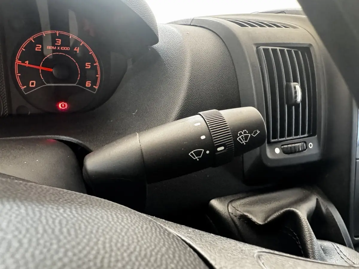 Gros plan intérieur sur le commodo d’essuie-glace et le tableau de bord noir du Citroën Jumper 2023.