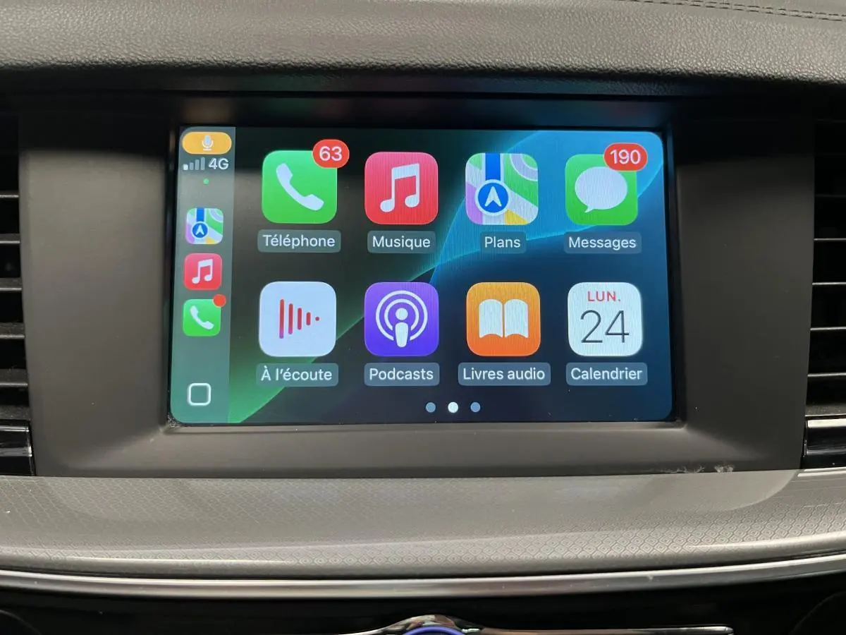 Écran tactile central de l'Opel Insignia Sports Tourer 2020 affichant Apple CarPlay avec icônes colorées.